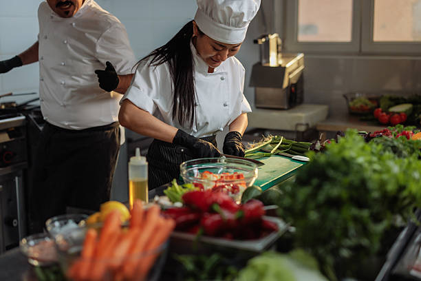 istock Chefs preparing fresh vegetables in a commercial kitchen 2217486777