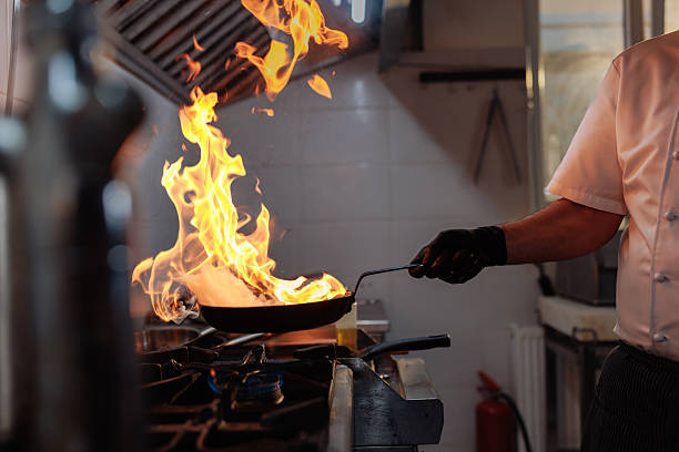 istock Professional chef cooking with fire in a pan in a restaurant kitchen 2217486807