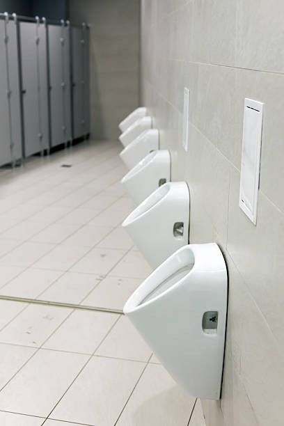 istock Large public men's toilet with white tiles 2217487324