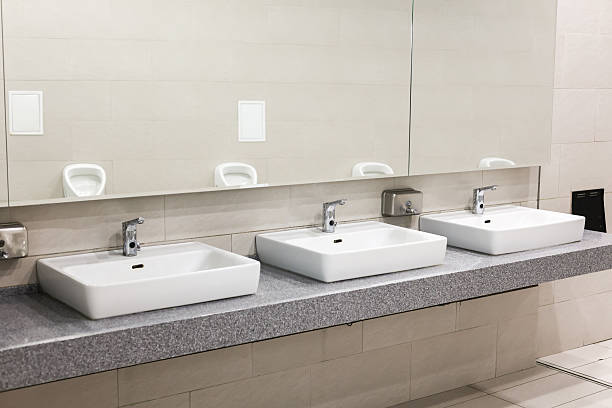 istock Large public men's toilet with white tiles 2217487367