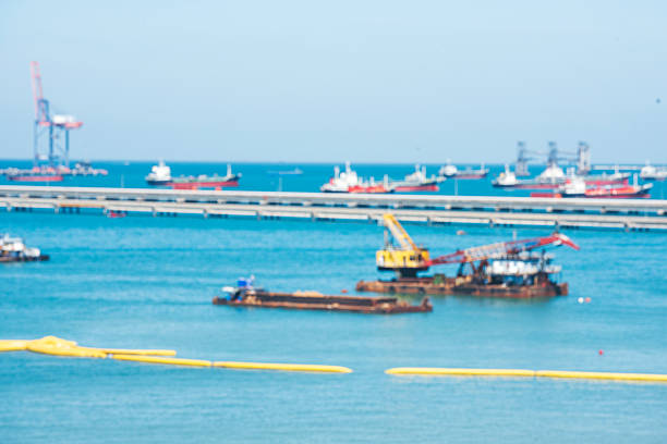 Logistic shipping quay boat Engineering crane depot at logistic export terminal control. Warehouse freight background container yard loading quayside harbor port. Logistics seascape shipping portal
