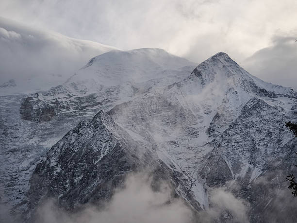 istock Snowy mountain peaks rising through misty clouds in chamonix, dramatic alpine landscape under winter's soft light 2217487801