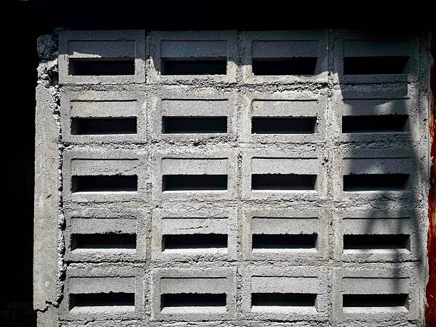Unfinished concrete ventilation roster arrangement on building walls