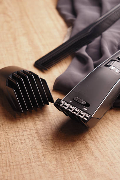 istock Essential grooming tools arranged on wooden surface for hair trimming 2217492589