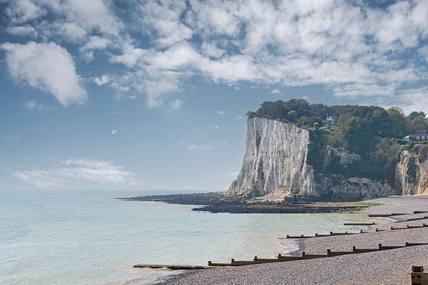 A craggy rock formation is viewed against a clear blue sky in Butter Rock - Dorset - Great Britain