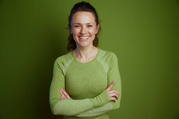 istock Approachable woman in green smiles 2217496115