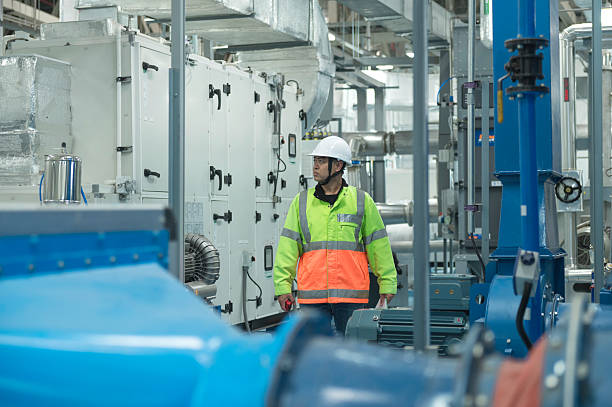 istock Asian Engineer Performing Pipe System Inspection in Modern Industrial Facility 2217496379