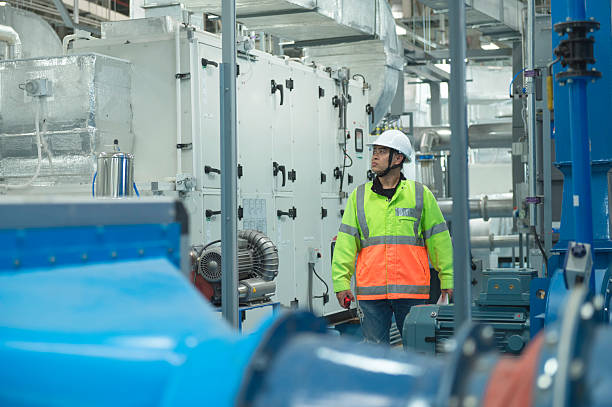 istock Asian Engineer Performing Pipe System Inspection in Modern Industrial Facility 2217496381