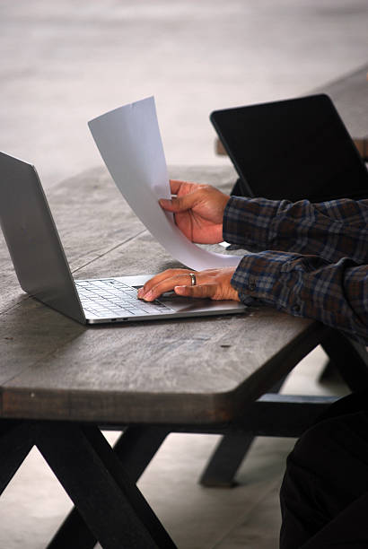 istock Close-up of hands working on a laptop and documents 2217496808