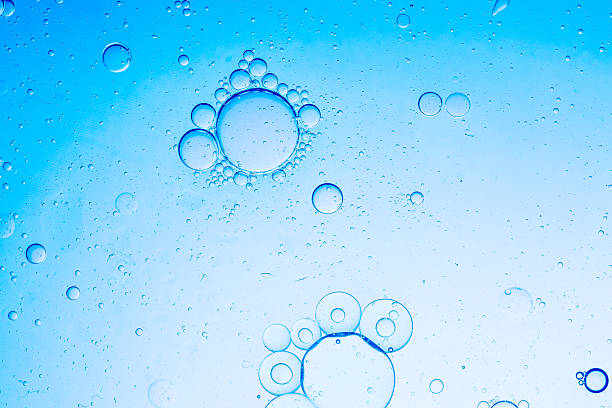 istock Close-up blue macro bubble texture,Effervescent fizz and clean cosmetics hygiene or rejuvenate renewable energy. Studio shot of transparent cosmetic blue gas bubbles under water in full-frame macro close up with selective focus blur. 2217498214