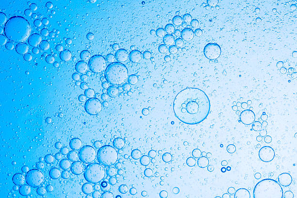 istock Close-up blue macro bubble texture,Effervescent fizz and clean cosmetics hygiene or rejuvenate renewable energy. Studio shot of transparent cosmetic blue gas bubbles under water in full-frame macro close up with selective focus blur. 2217498221