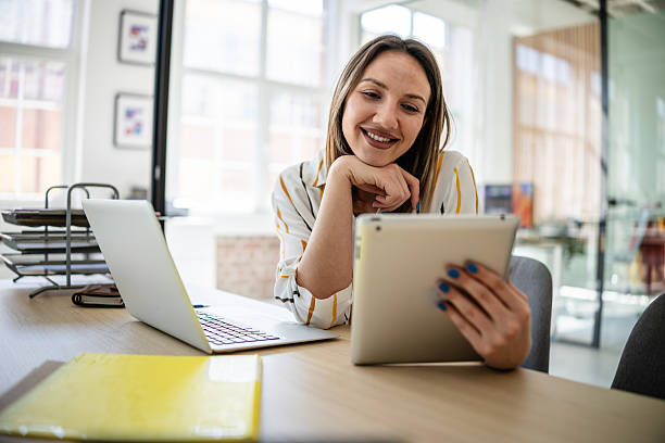 istock Young businesswoman engaged in digital communication while working efficiently in a modern office environment 2217498788
