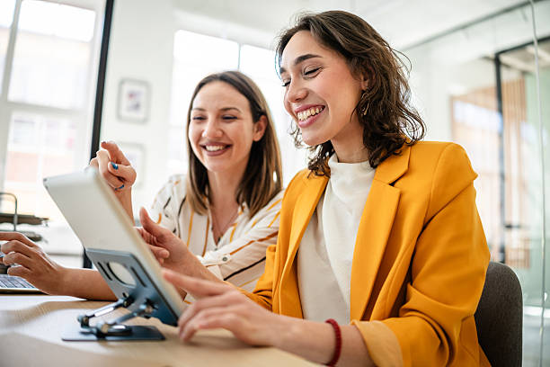 istock Young businesswomen collaborating in a modern office, sharing ideas and enjoying their work environment 2217499178