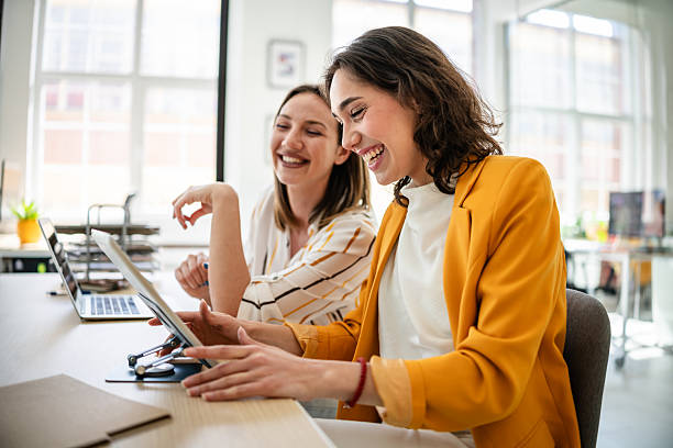 istock Young businesswomen engaging in a lively discussion while working in a modern corporate office setting 2217499321