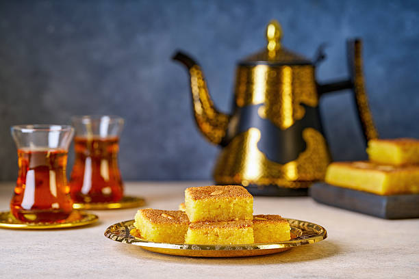 istock Middle eastern traditional semolina cake basbousa , namoora, hareesa served with tea 2217499521