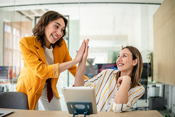istock Young businesswomen engage in a lively discussion while collaborating in a modern office setting, sharing smiles and ideas 2217499712
