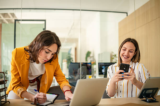 istock Young businesswomen collaborating in a modern office environment while discussing ideas and utilizing technology 2217499905