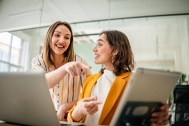 istock Young businesswomen engaged in a lively discussion in a modern office setting during a productive work session 2217501035