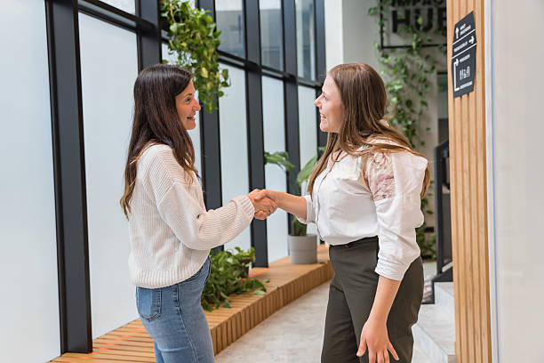 istock Young women coworkers shake hands 2217501191