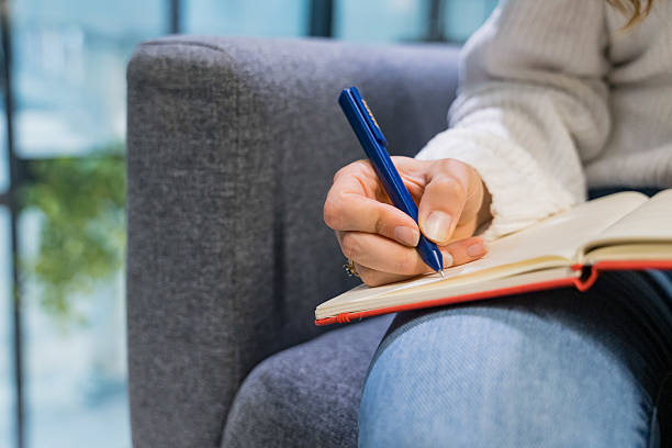 istock Young businesswoman writes in notebook 2217501466
