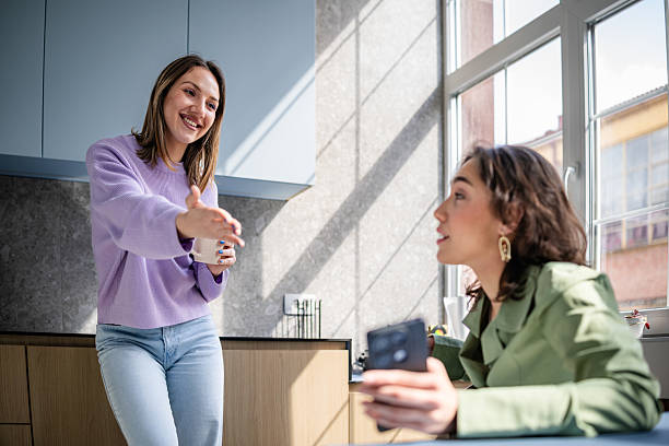 istock Young businesswomen engage in a friendly discussion in a modern office setting 2217501829