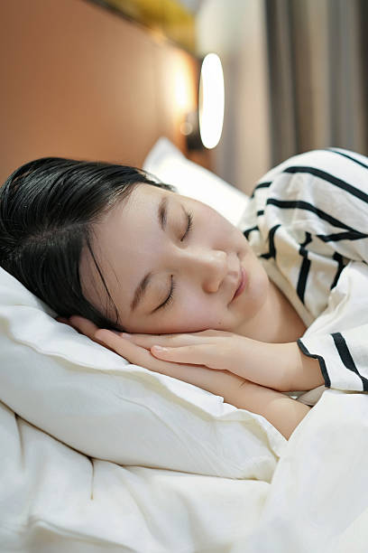 istock Peaceful Sleeping Woman in Bed 2217501974