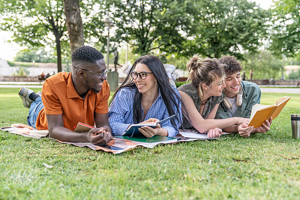 istock Students relaxing and studying together in the park 2217502357