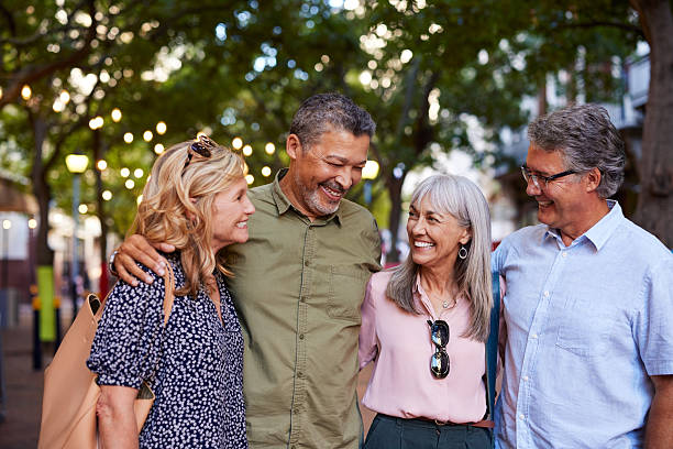Happy multiethnic mature friends laughing together