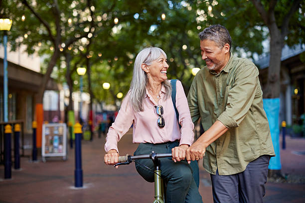 istock Mature multiethnic couple having fun during a stroll with bike 2217502499