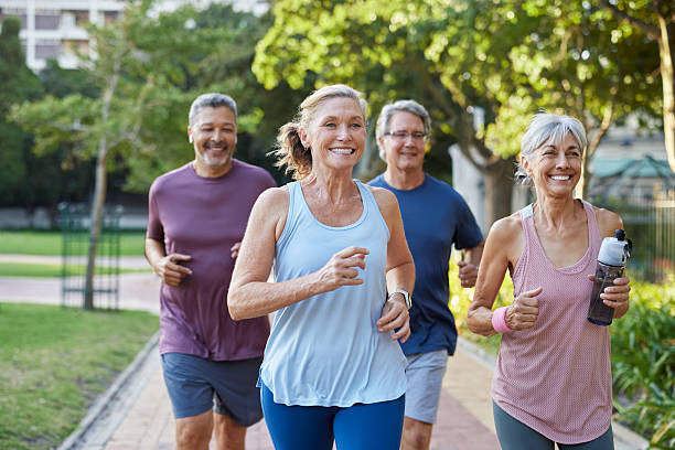 istock Senior healthy group jogging together at park 2217502626
