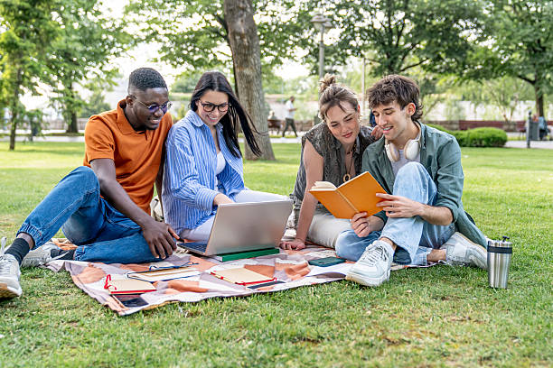 istock University students studying together in the park 2217502832