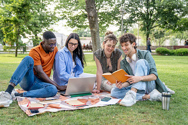 istock University students studying together in the park 2217502882