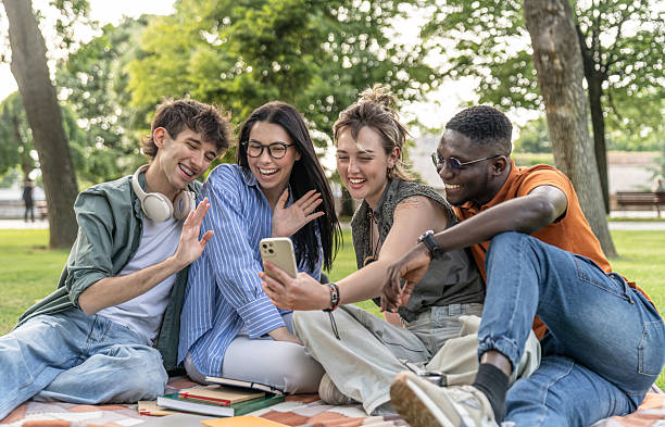 istock Cheerful university students making video call in park 2217503052
