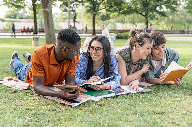 istock Students relaxing and studying together at the park 2217503263