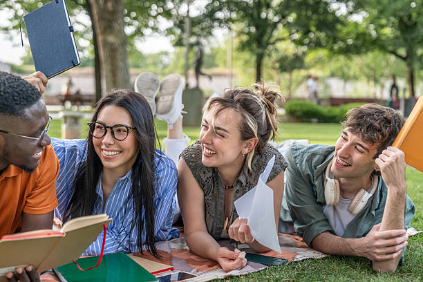 istock Cheerful university students studying together in park 2217503549