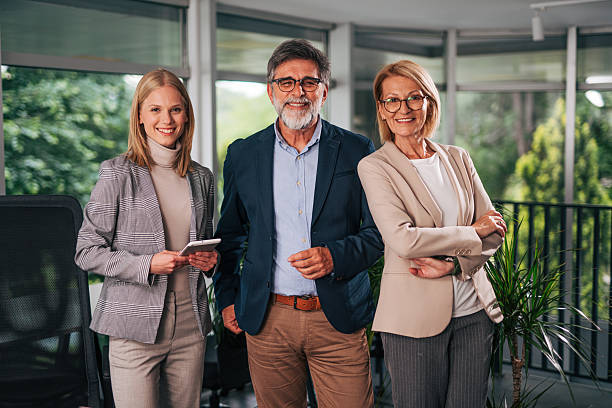 istock Smiling business team posing together in modern office 2217503662