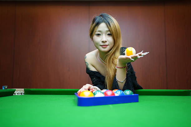 Young woman holding billiards