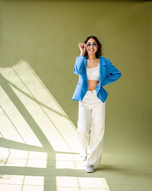 istock Young woman posing confidently in a photography studio with creative lighting 2217506175