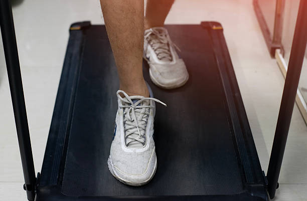 Men exercise on the treadmill in the gym.