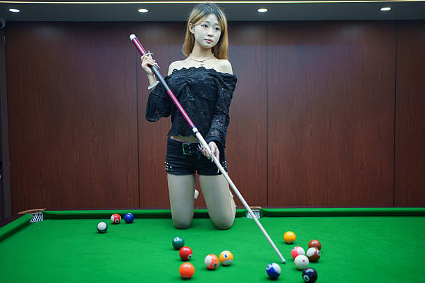 istock Young woman kneeling on the pool table 2217506977