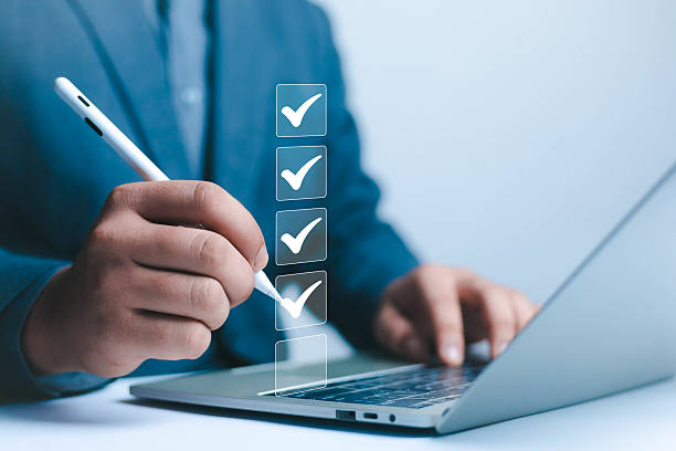 istock Business Performance Checklist Businessman Using Laptop Doing Online Checklist Survey On Computer Filling Out Digital Form Checklist Survey Doing Assessment Questionnaire Evaluation 2217508895