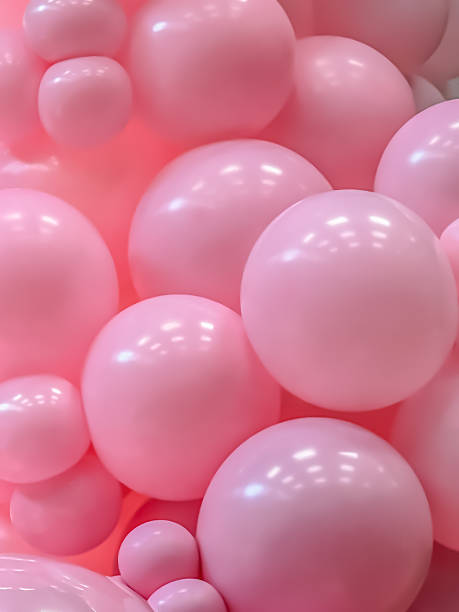 istock Glossy Pink Balloons Forming Bubbly Abstract Background 2217509467