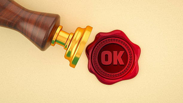 A clean and classic 3D illustration symbolizing approval, validation, and agreement. A traditional wooden and gold stamp rests beside a freshly pressed red wax seal with the word \