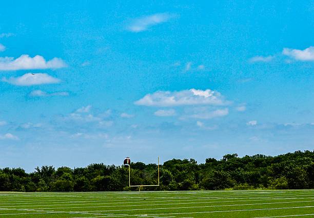 A football field, also known as a gridiron in American football, is a rectangular playing surface covered in grass or artificial turf.