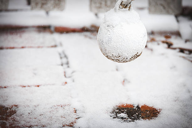 The ball of a gate closer, on an outside door, gathers snow during a February snowstorm at Williamsburg, Virginia.