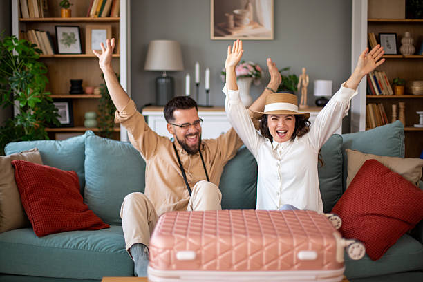 istock Excited tourists cheering while planning their vacation trip 2217521727
