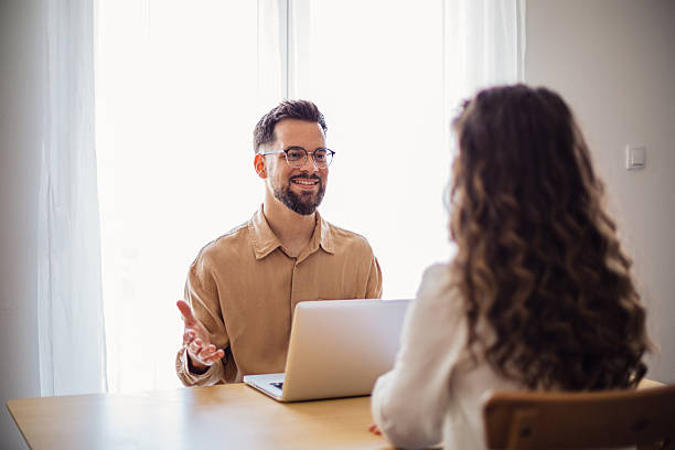 istock Business partners discussing a project using a laptop in their bright office 2217523372