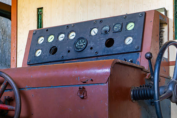 istock Interior view of an old locomotive cabin featuring a control panel with numerous gauges, dials, and knobs 2217526186