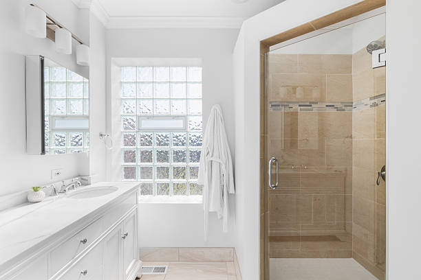 istock A white bathroom with a brown tiled shower. 2217528170