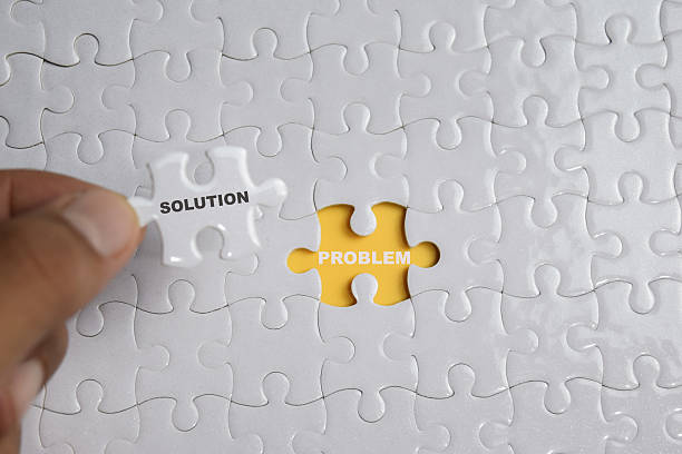 istock Hand holding piece of jigsaw puzzle with word solution problem. Business and finance concept 2217529425
